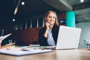 Smiling woman looking at laptop