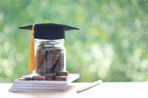 Jar of coins with graduation cap