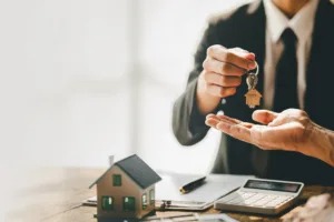 Man handing home keys to homeowner