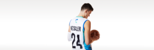 Walker Kessler holding basketball from back wearing UCCU jersey